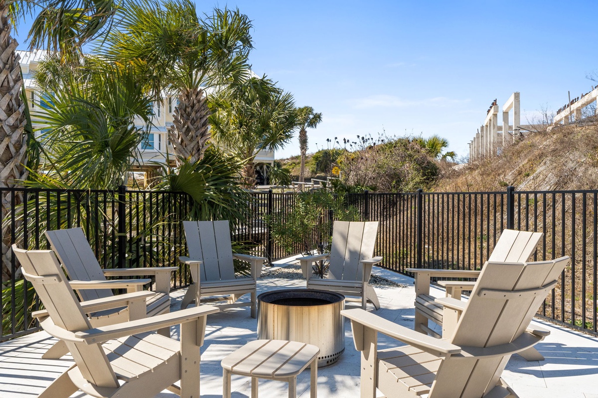 Relax on your private terrace with Adirondack chairs and fire pit, surrounded by tropical palms and coastal charm.