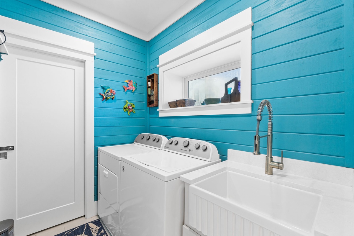 Your cheerful laundry room makes vacation chores a breeze with its bright turquoise walls and modern appliances.