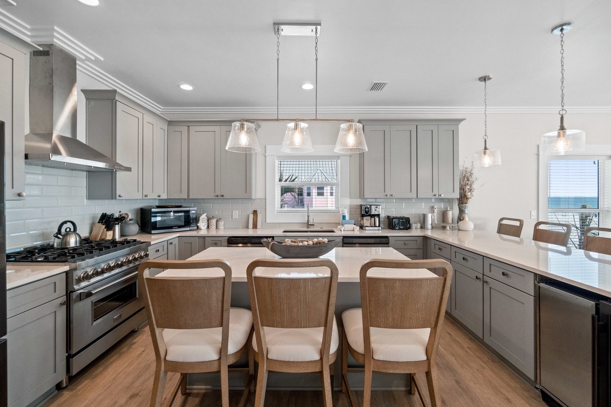 Gather around this elegant kitchen island where you'll create meals together, featuring premium appliances and ocean views.