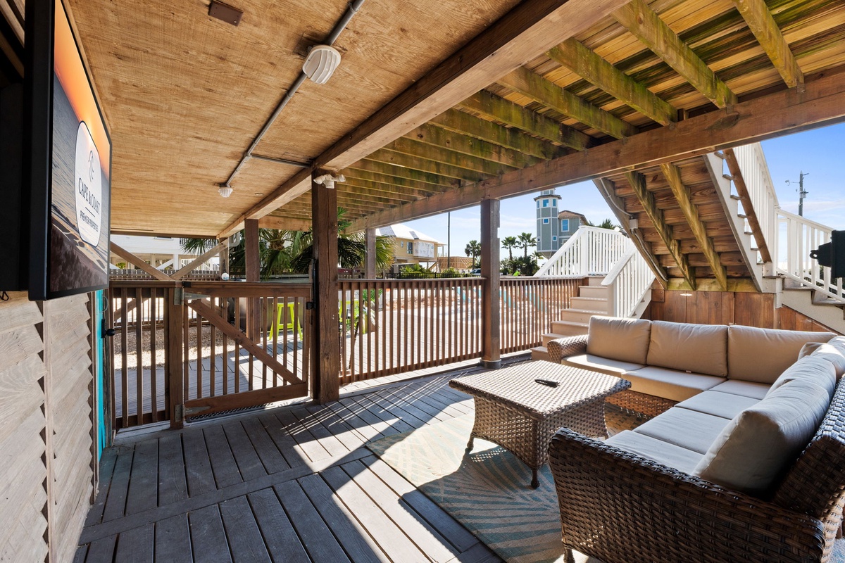 A comfortable outdoor living area with seating and TV makes it easy to unwind after a full day in the sun.
