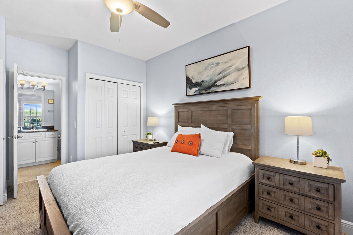 Sink into crisp linens and rustic wood furniture in your peaceful retreat, where soft lighting and calming blue walls create the perfect sanctuary for rest.