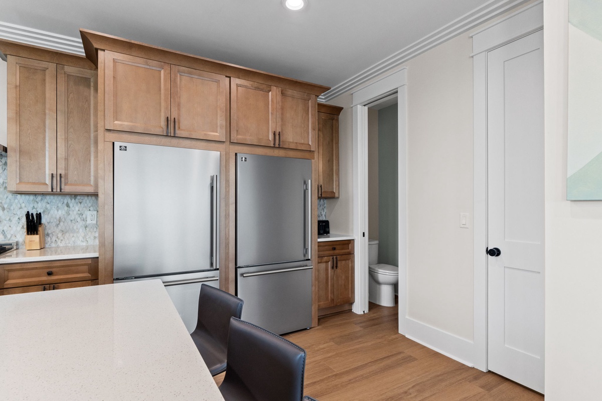 Your spacious kitchen features warm wood cabinetry, stainless steel appliances, and convenient access to a private bathroom—comfort and style perfectly blended.
