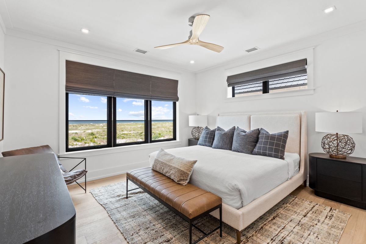 Wake up to stunning ocean views from your bed in this serene, thoughtfully designed bedroom. Crisp linens, coastal breezes from the ceiling fan, and the sound of waves nearby make every morning feel like a dream.