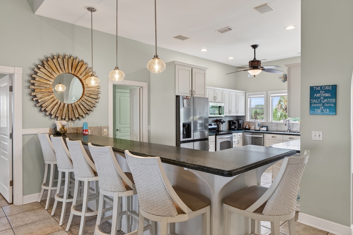 Gather around your spacious breakfast bar where stylish pendant lights create the perfect ambiance for morning coffee or evening cocktails.