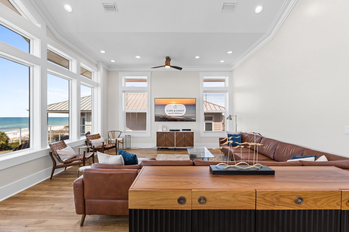 Sink into plush leather seating while watching your favorite shows, with stunning ocean views framing your relaxation time in this sophisticated living space.