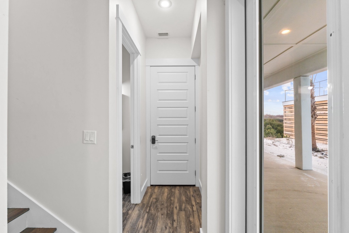 Your bright hallway connects you to comfortable spaces, with natural light streaming through floor-to-ceiling windows.