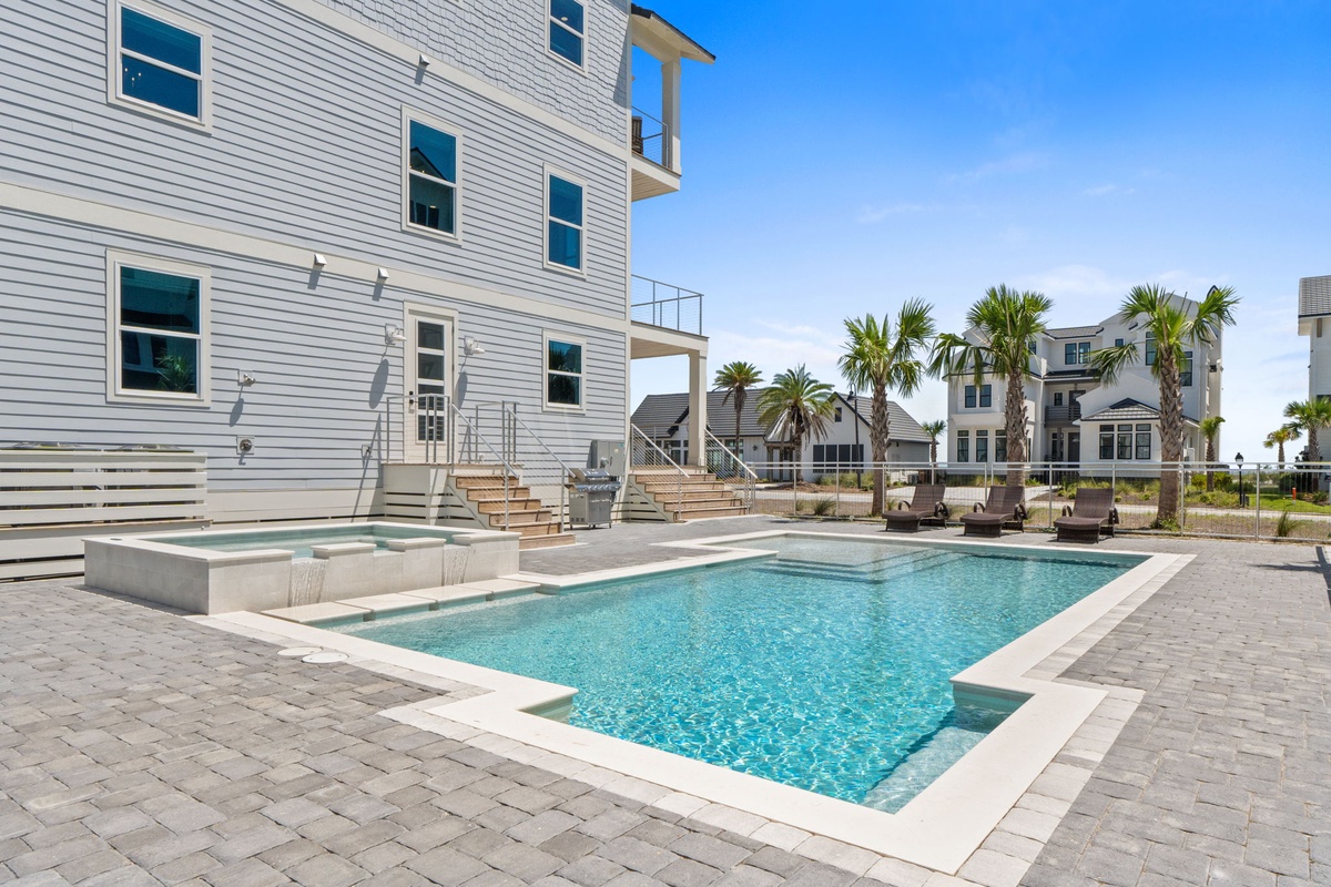 A bright coastal getaway awaits in this modern beach retreat. With a sparkling pool steps from your door and swaying palms all around, you'll feel the vacation vibes the moment you arrive.