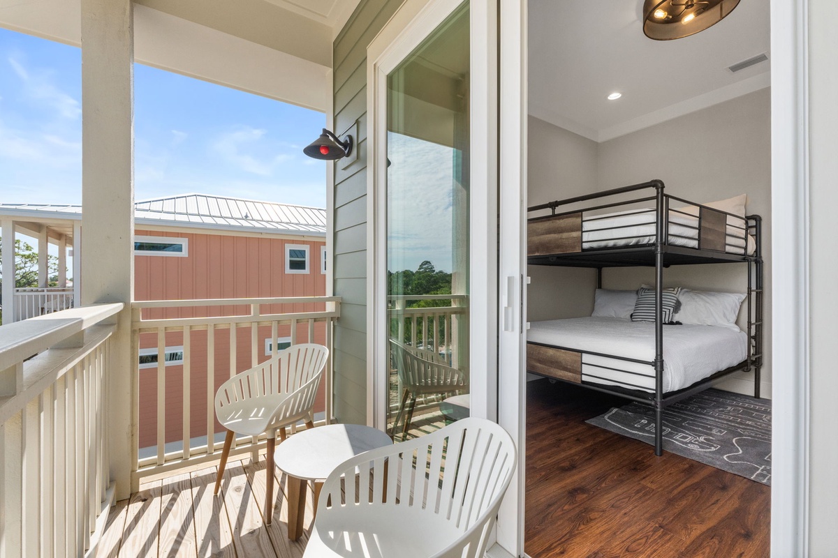 Your cozy bedroom opens to a private balcony where morning coffee feels perfect with neighborhood views.