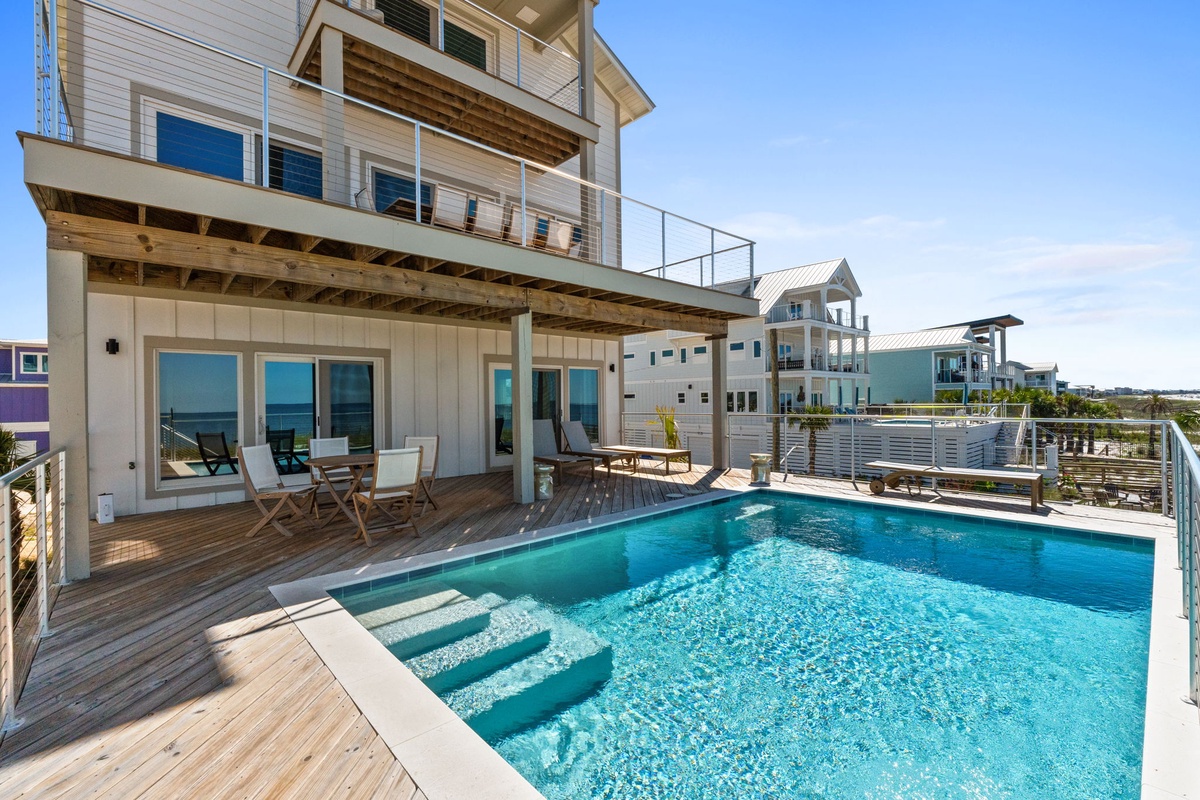 Stunning private pool with deck lounge seating. Steps lead into the crystal-clear water, perfect for cooling off under the sun or relaxing poolside.