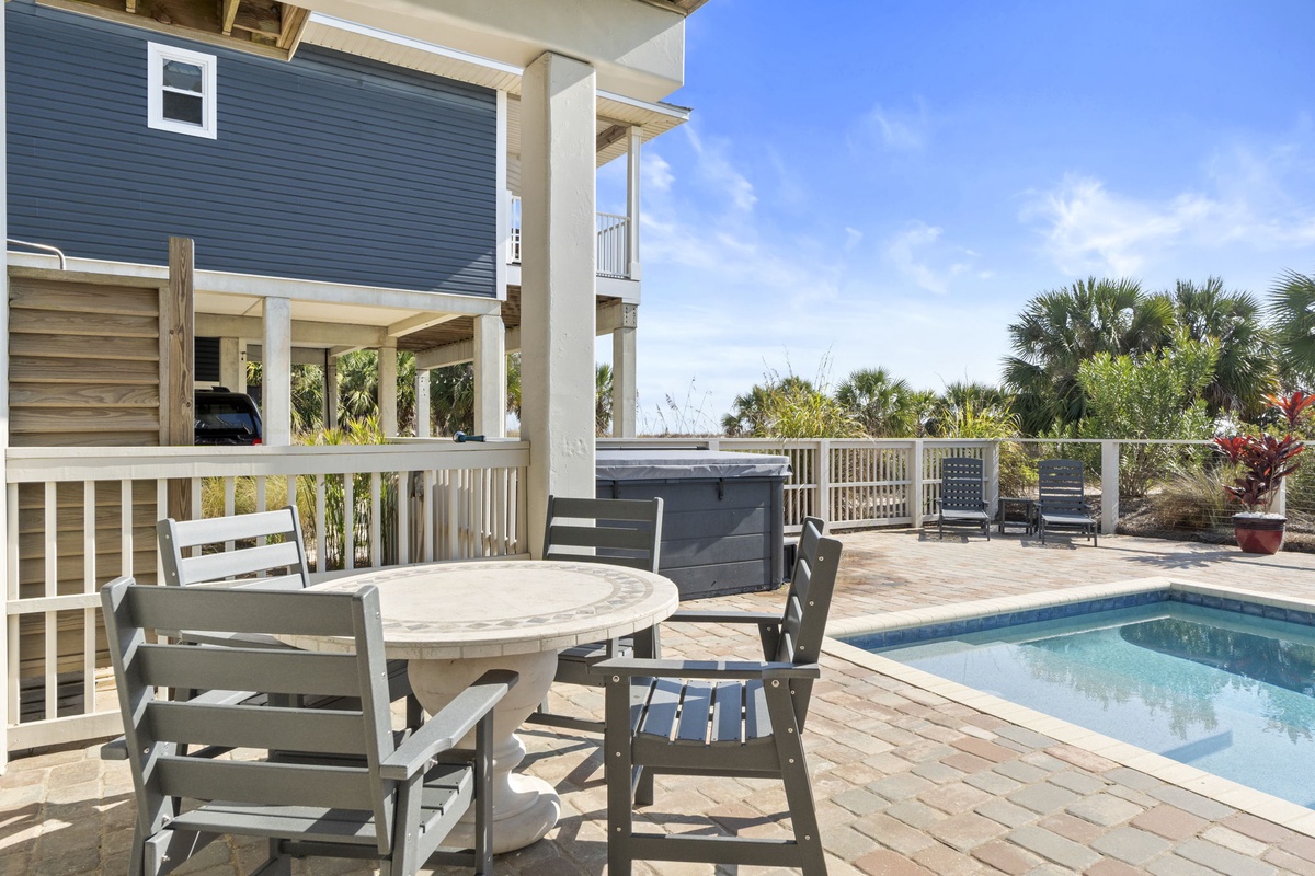 Step onto your private deck where outdoor dining meets poolside bliss, complete with hot tub and tropical palm views.