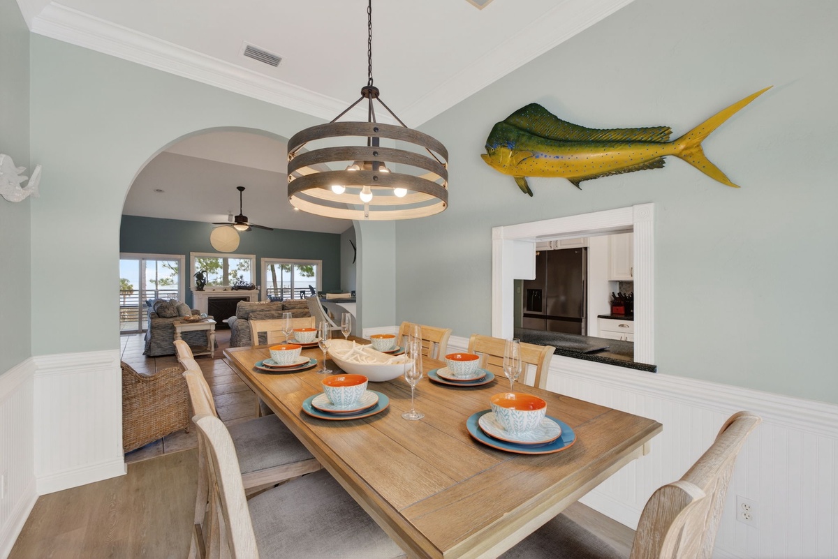 Gather around your stunning dining table for memorable meals with ocean-inspired décor overhead.