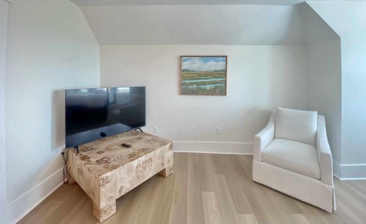 Settle into your cozy upstairs loft with a plush armchair and TV—perfect for relaxing after exploring the area or watching your favorite shows.