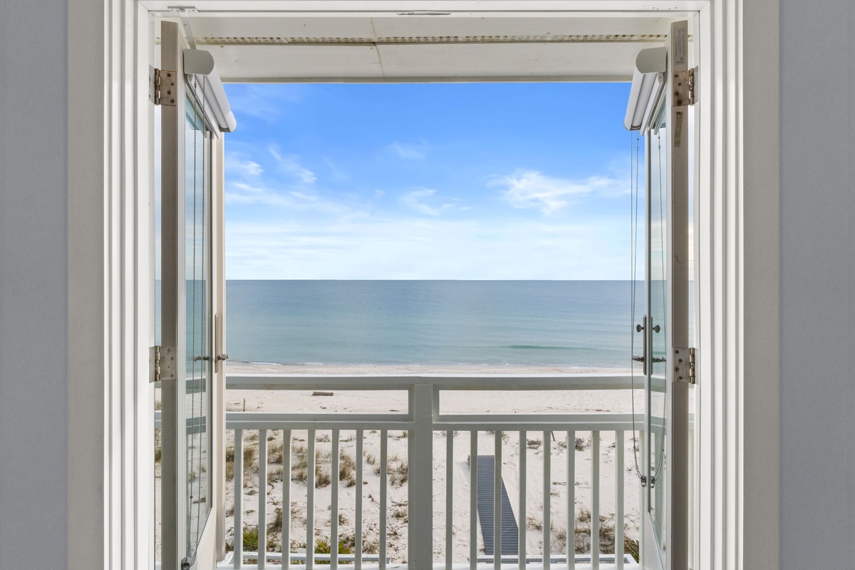 Step onto your private balcony and breathe in the ocean breeze as endless sea views stretch before you through open doors.