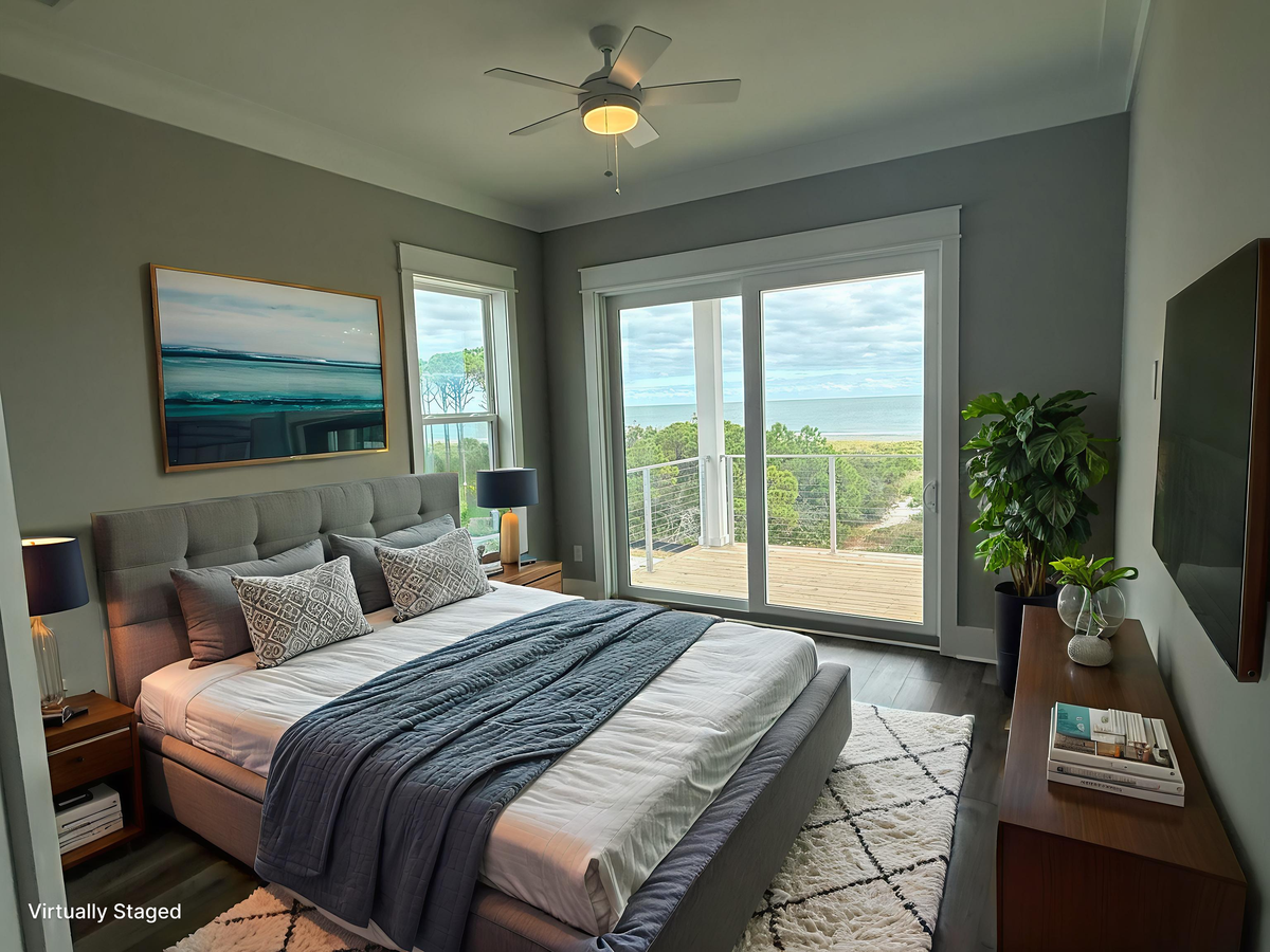 Unwind in your stylish bedroom featuring ocean views through floor-to-ceiling windows and private balcony access.