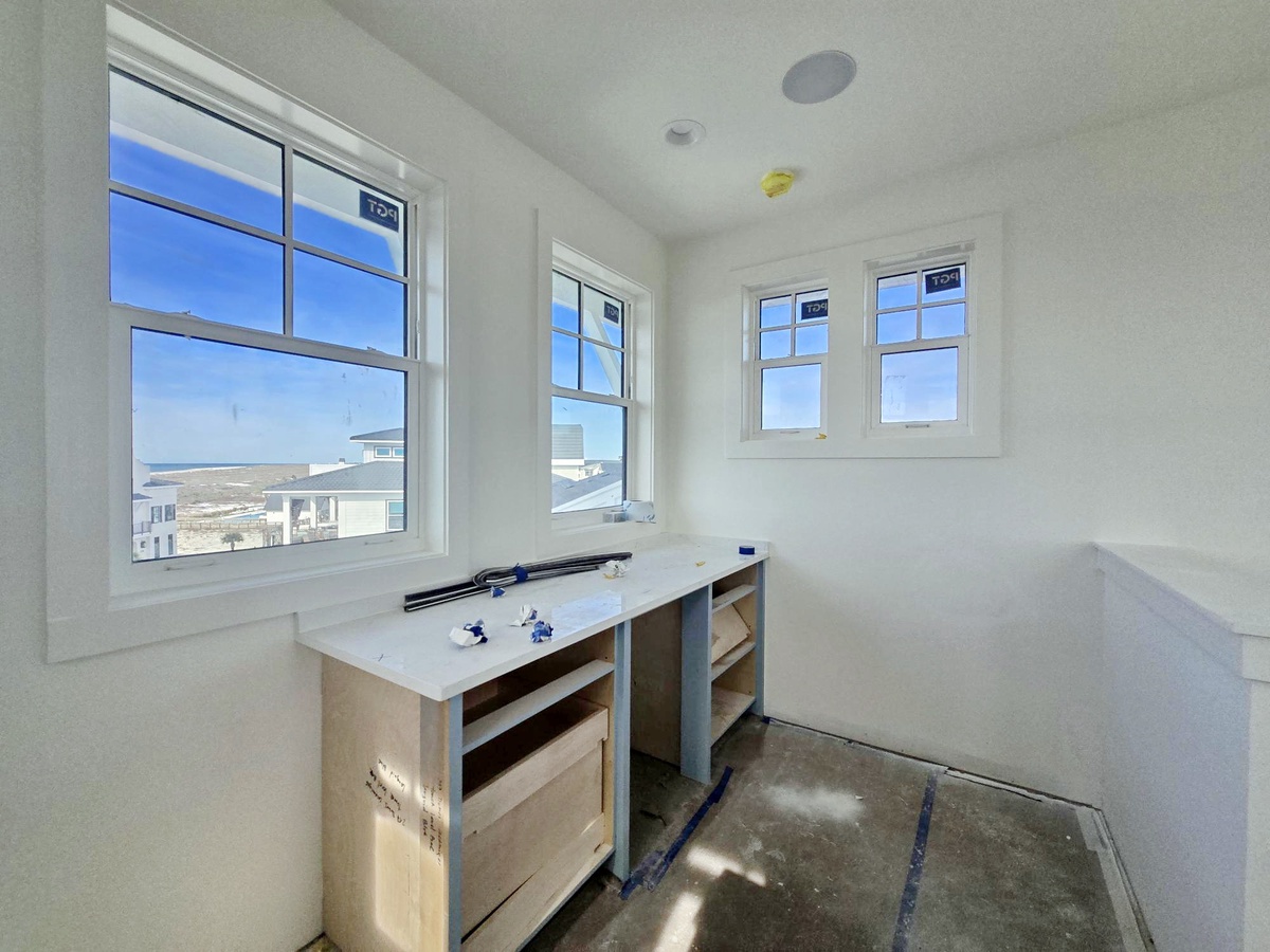 Your bright master bathroom features dual vanities and stunning ocean views through multiple windows.