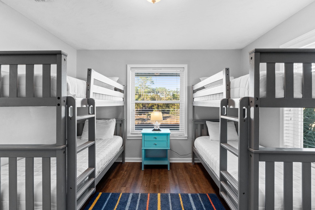 Rest well in your cozy bunk room with four comfortable beds, crisp linens, and natural light streaming through your window.