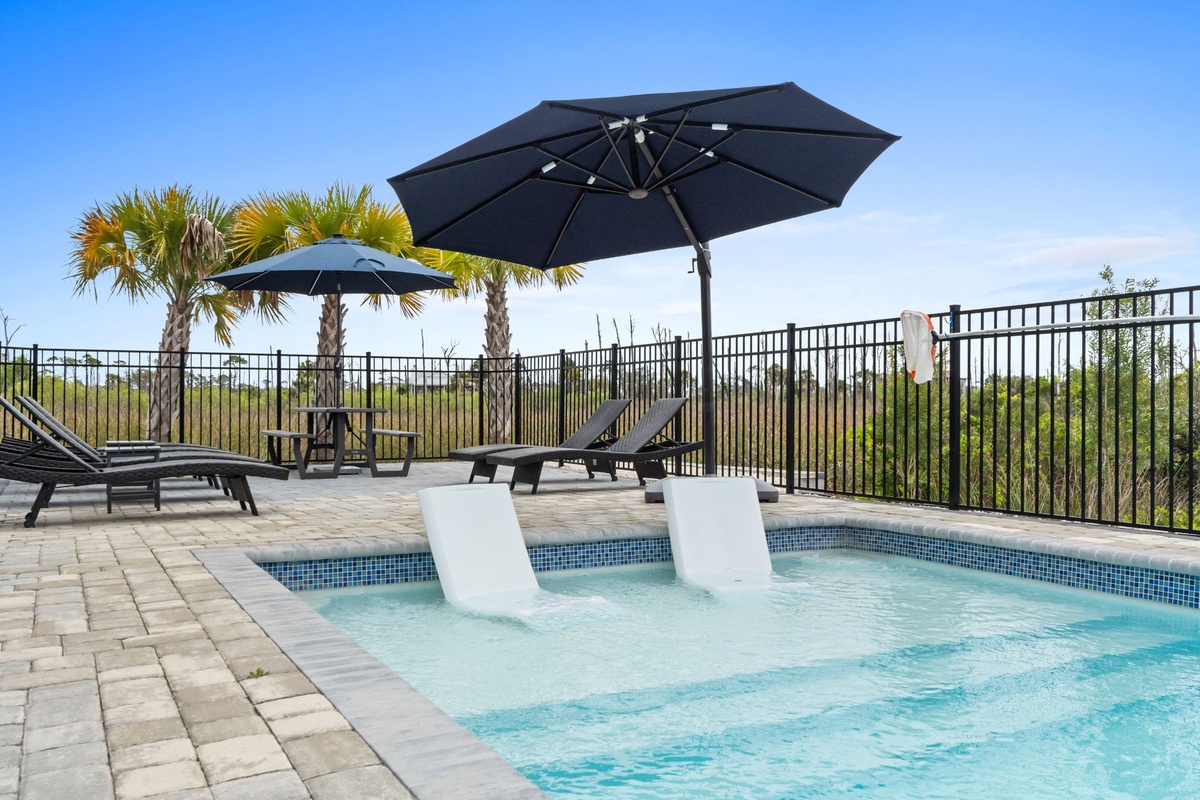Soak in sun loungers or cool off in crystal-clear waters while tropical palms sway above your private paradise.