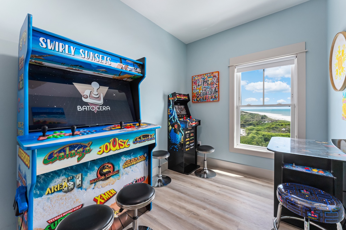 Step into your private arcade paradise where classic gaming meets breathtaking ocean views, perfect for family fun.
