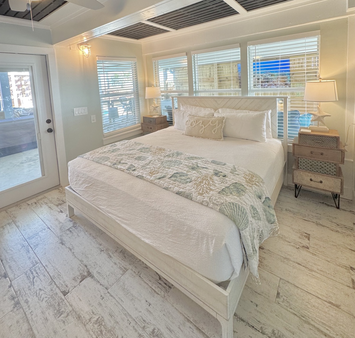 Drift into peaceful dreams in your coastal-inspired bedroom featuring crisp white linens and warm nautical touches that make every night feel like a seaside retreat.