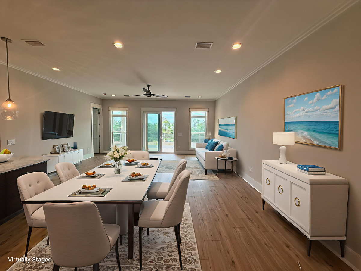 Relax in your elegant open-concept living space where modern comfort meets coastal charm through gorgeous ocean artwork and serene styling.