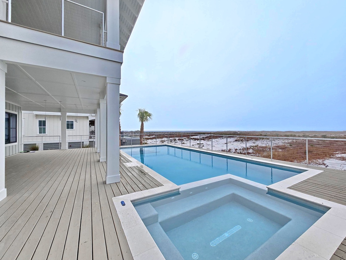 Modern beachfront property features a stunning pool deck with panoramic coastal views and contemporary design.