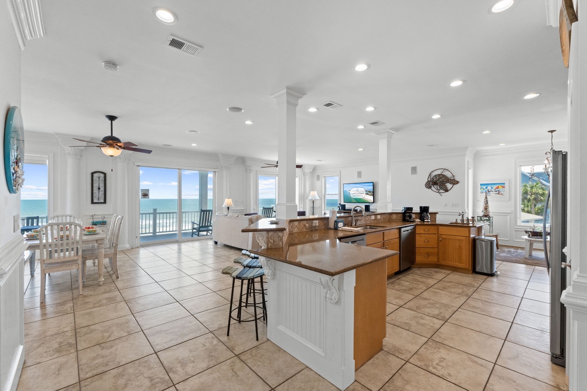 Step into this airy, sunlit space where ocean views greet you from every angle. Your mornings begin with coffee at the island, your afternoons unwind on the balcony, and your evenings gather loved ones around the dining table—all framed by endless blue.