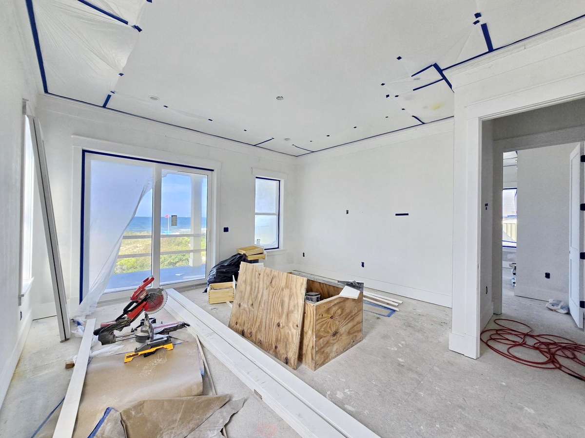 This bright, spacious room is taking shape with beautiful ocean views through large windows. The open layout will soon become your comfortable retreat by the sea.