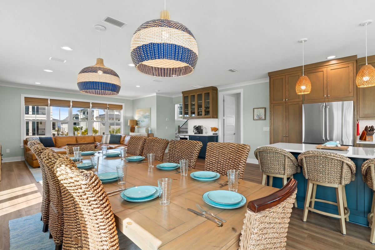 Gather around your spacious, sun-filled dining and living area with stylish woven seating and a well-appointed kitchen ready for meal prep and conversation.