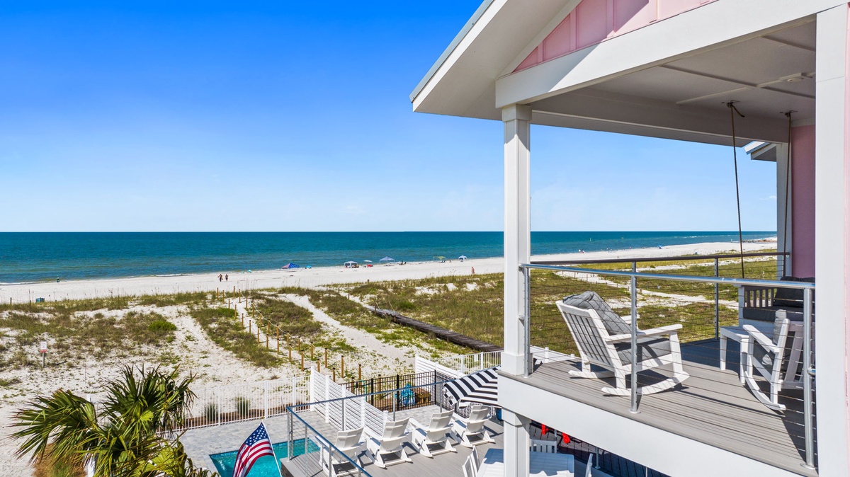 Beachfront property offering direct access to white sand shores and turquoise Gulf waters, with covered balconies and coastal views.
