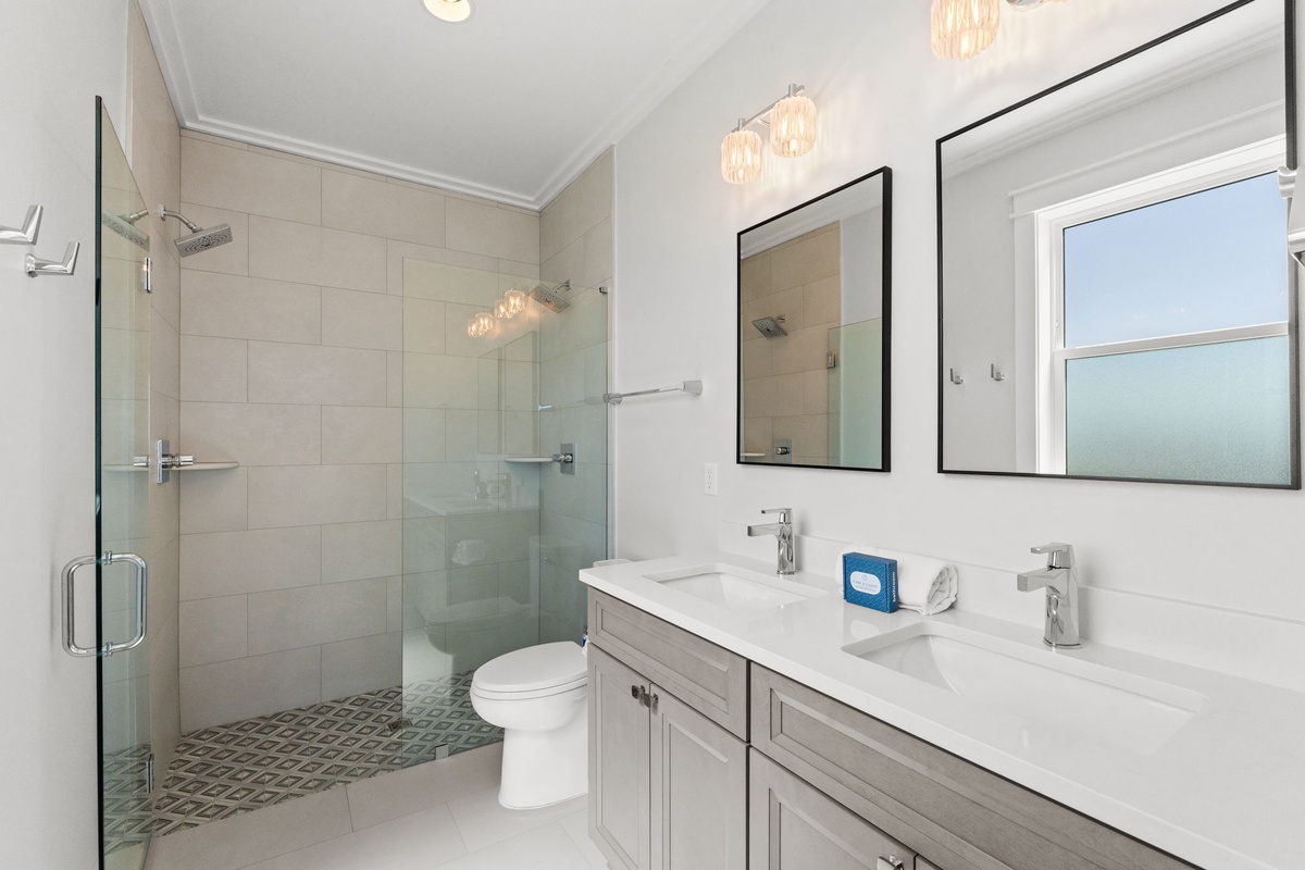 Refresh in this modern spa-like bathroom featuring dual sinks, a spacious walk-in shower, and elegant fixtures that make your daily routine feel like a retreat.