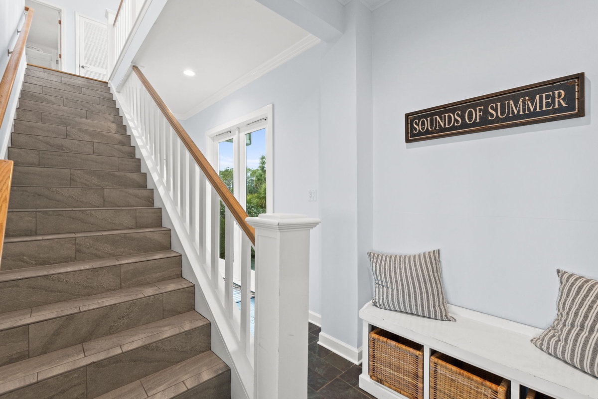 Your entryway greets you with coastal charm—drop your bags on the built-in bench and feel summer vibes wash over you.