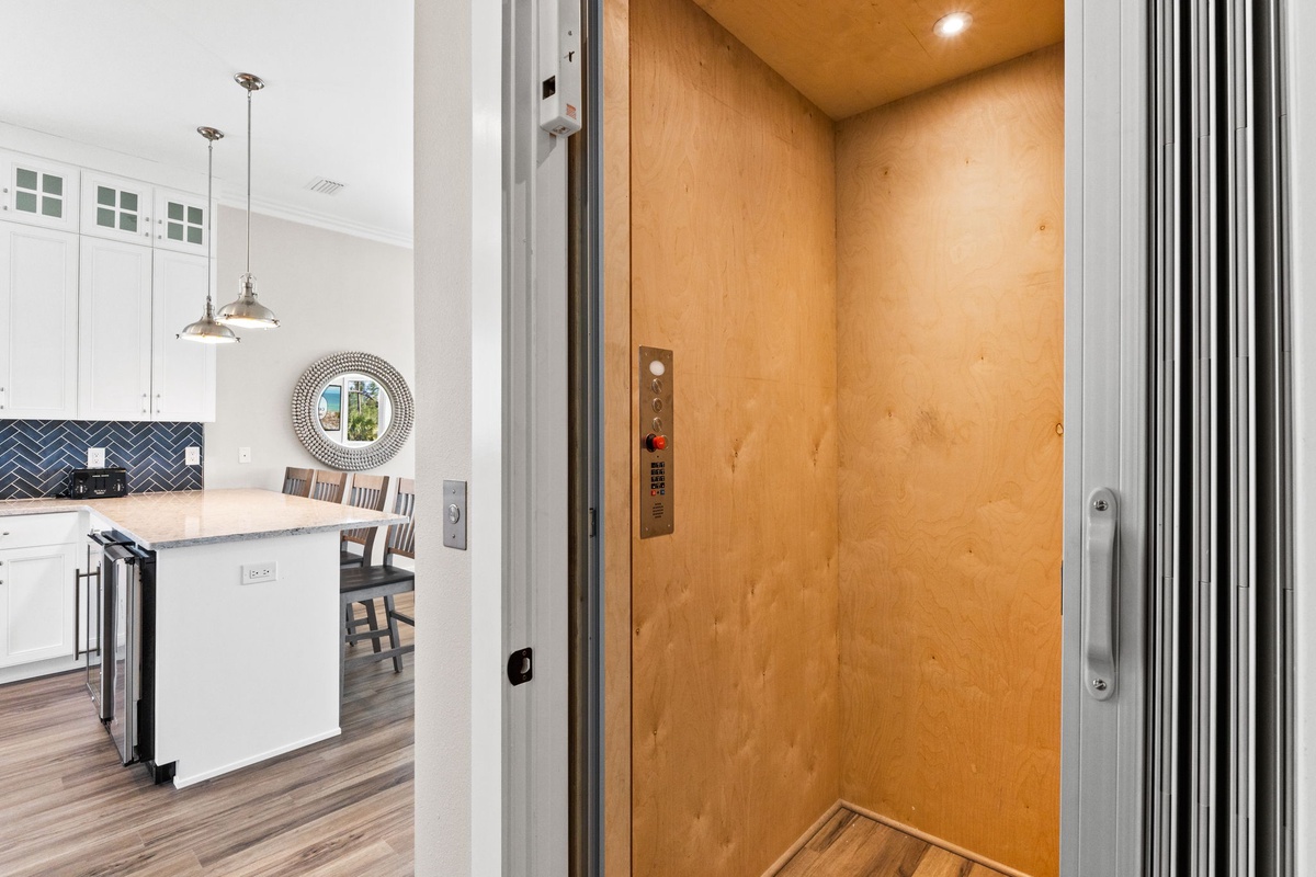Step into your private elevator that connects you seamlessly to your stylish kitchen with modern appliances and elegant design.