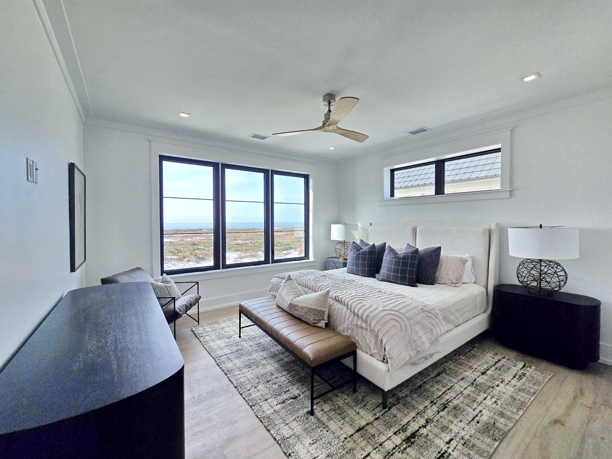 Wake up to sweeping landscape views from your serene bedroom, where modern comfort meets natural beauty through expansive windows.