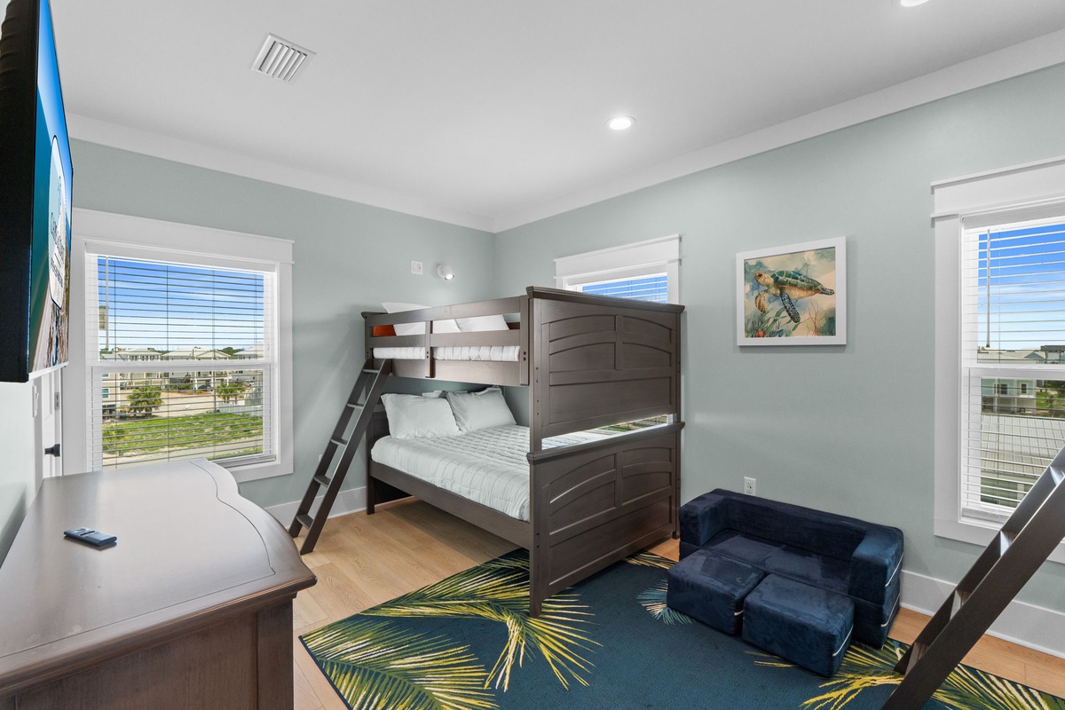 Your kids will love the bunk beds and extra play space in this cheerful room, with sunny windows and colorful décor creating the perfect spot for fun and rest.
