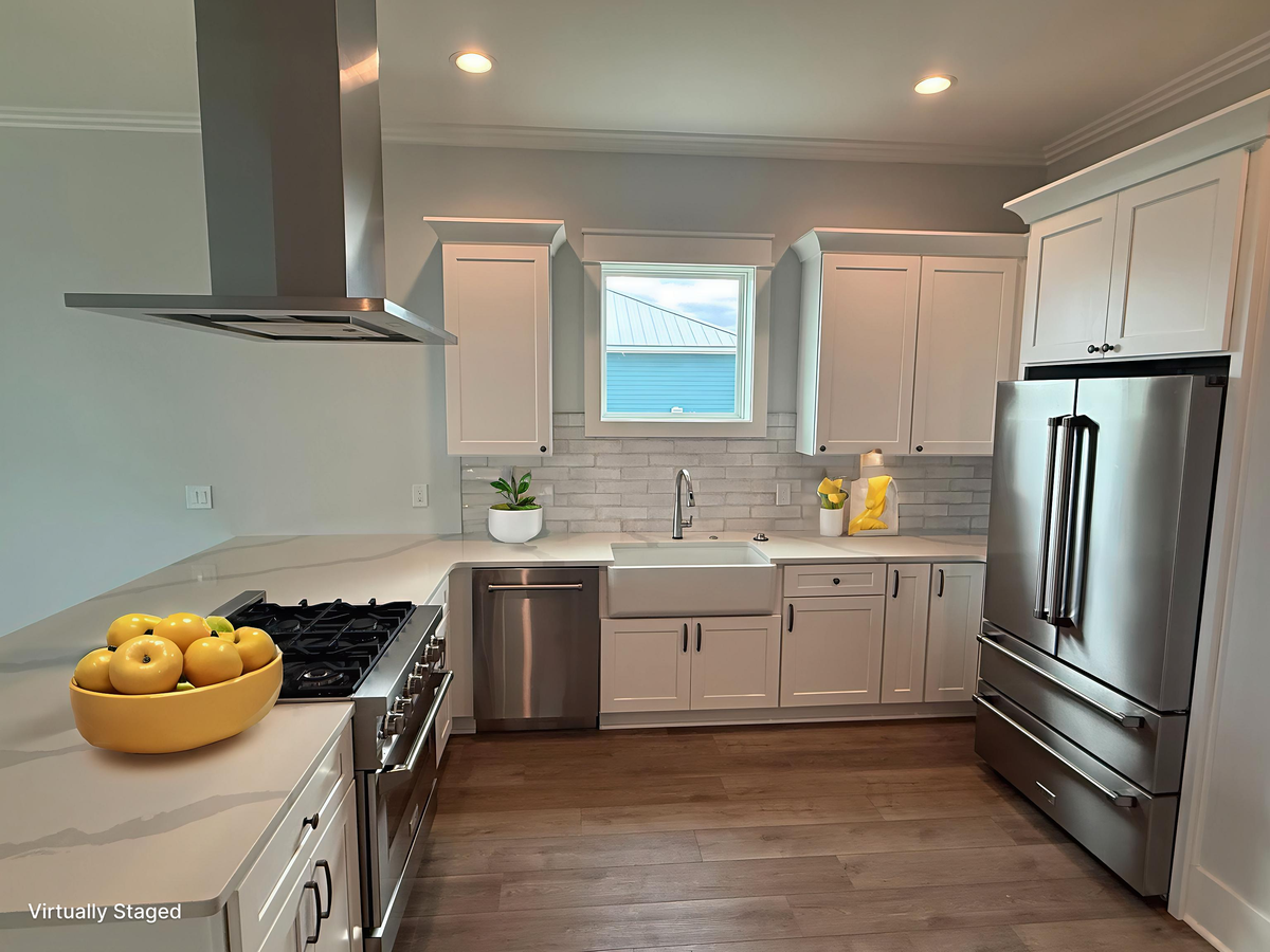 You'll love preparing meals in this bright, modern kitchen with gleaming stainless steel appliances and elegant white cabinetry.