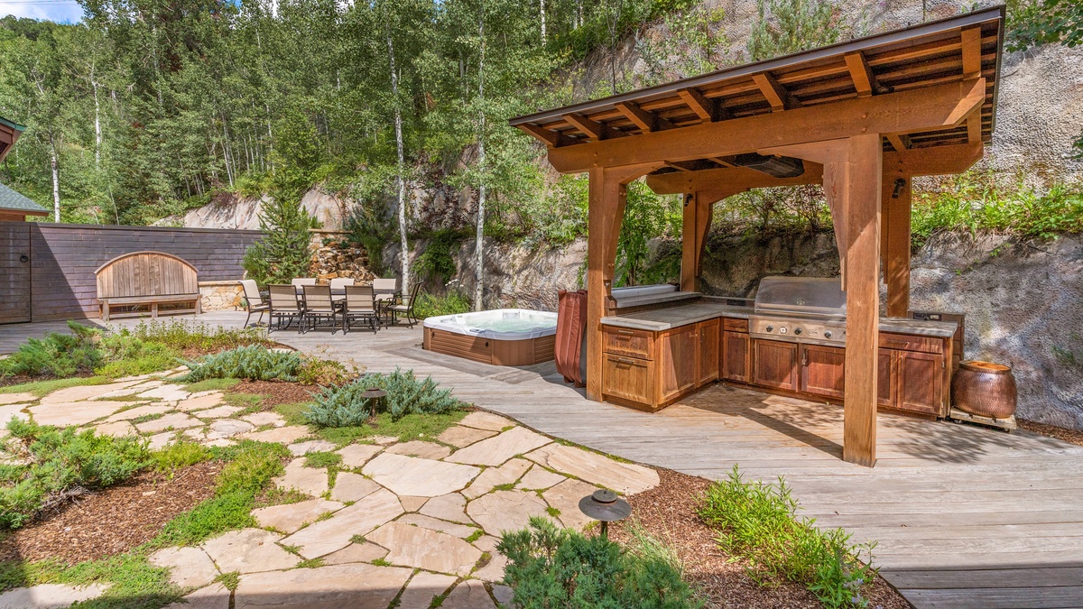 Back patio grill and hot tub in summer
