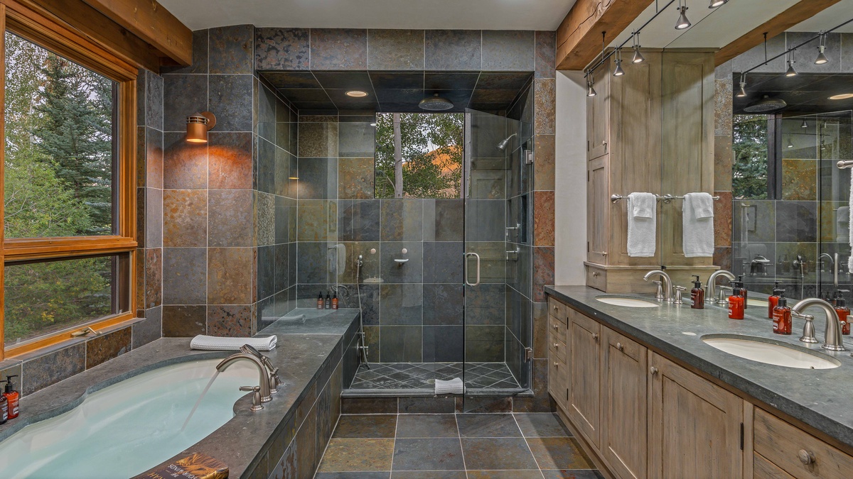 Bedroom 1, Main Level - Primary ensuite with shower, dual vanities, and soaking tub