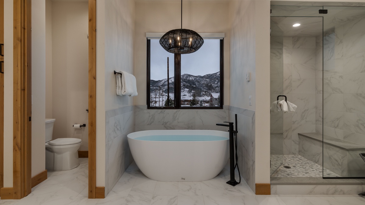 Primary bathroom with a soaking tub and separate shower