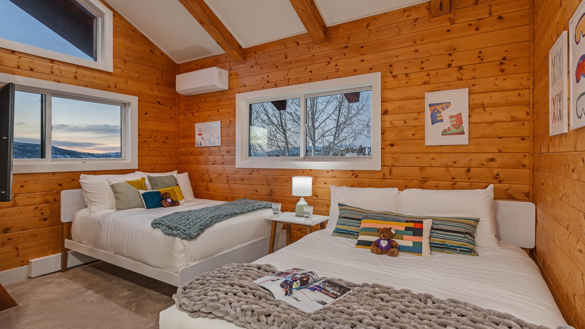 This upper level bedroom has a queen bed and full with a shared bath and extra loft level