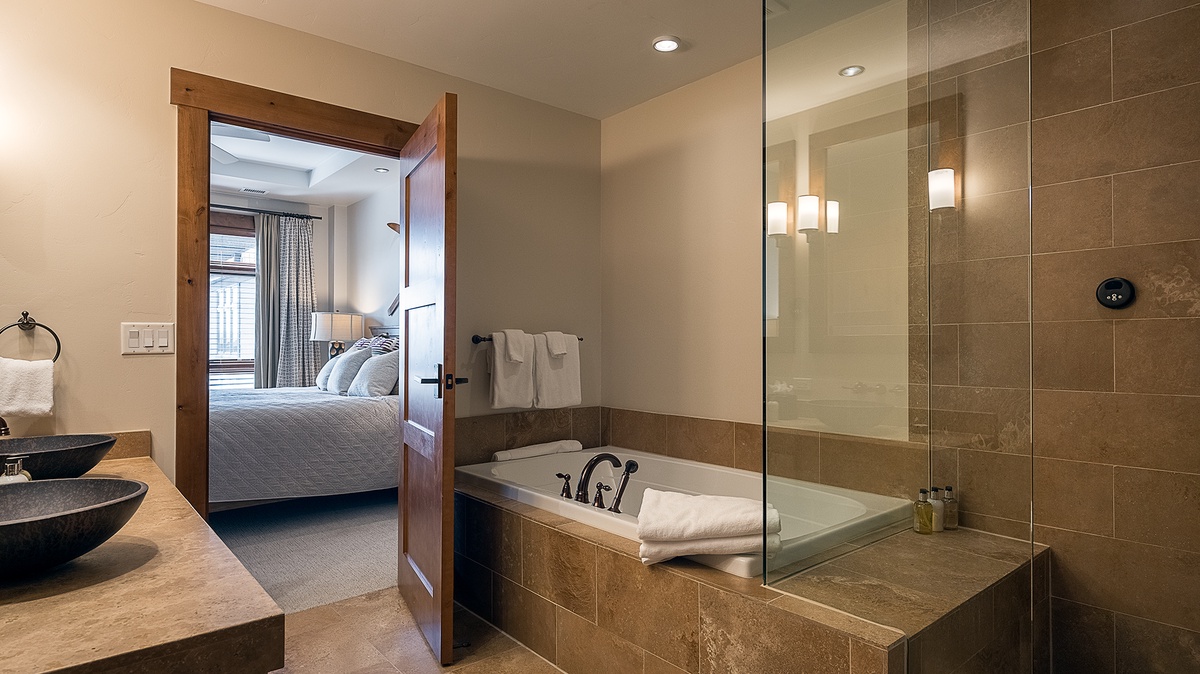 Bedroom 1, Main Level - Primary ensuite with soaking tub and walk-in shower