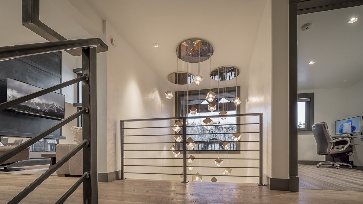 Stairs from entryway to main floor showing office and living room