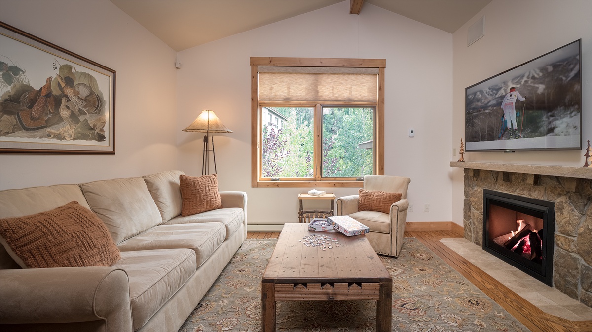 Family Room, Main Level - Comfortable seating area with large window and natural light.