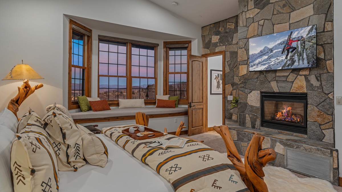 Primary king suite on upper level with gas fireplace