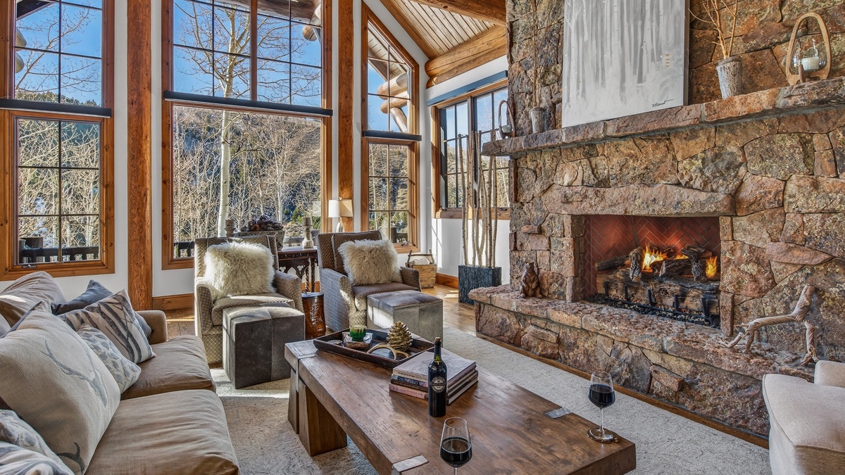 Great Room, Main Level - Cozy seating area with stone fireplace and mountain views