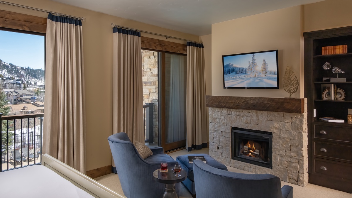 Bedroom 1, Main Level - Enjoy quiet mornings or evenings at the fireplace in the primary bedroom.