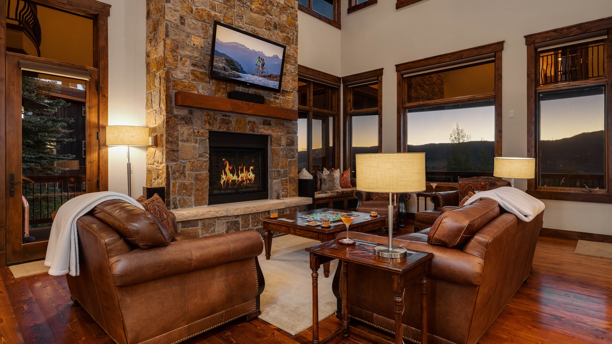 Great Room, Main Level - Stone fireplace with leather seating and mountain lodge ambiance