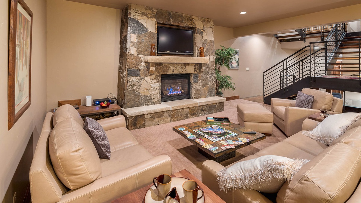 Lower level family room with fireplace, TV