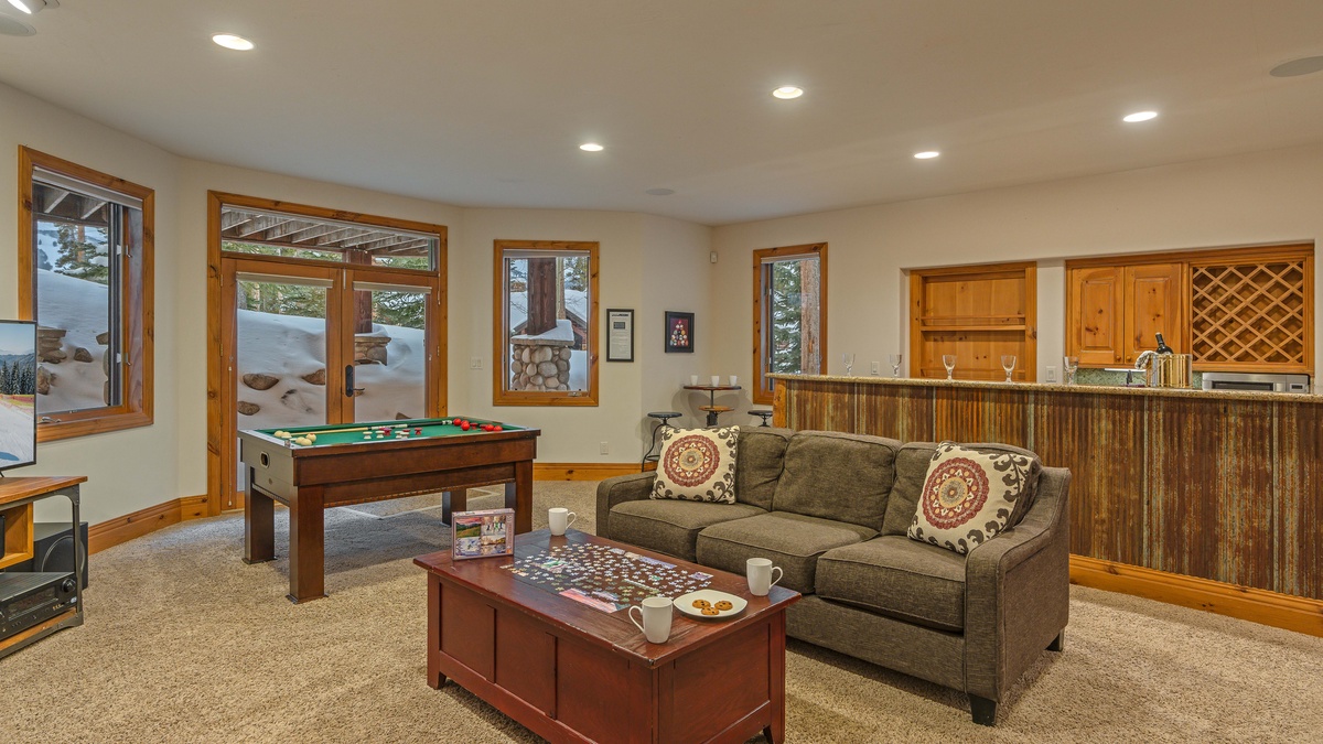 Family room on lower level with wet bar and bumper pool table