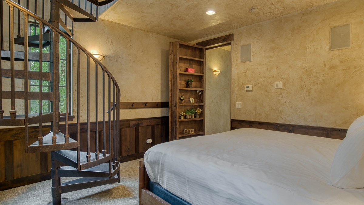 Secret room with King bed on upper level with spiral staircase to the secret library