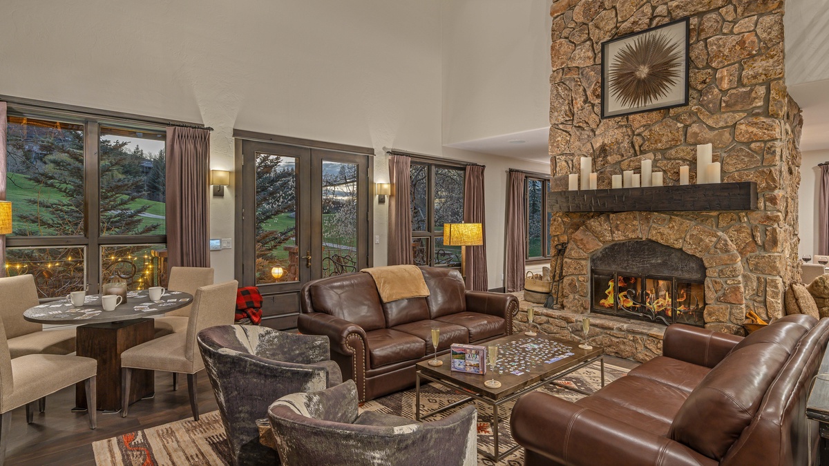 Great room on the main (4th) level with wood fireplace and deck access